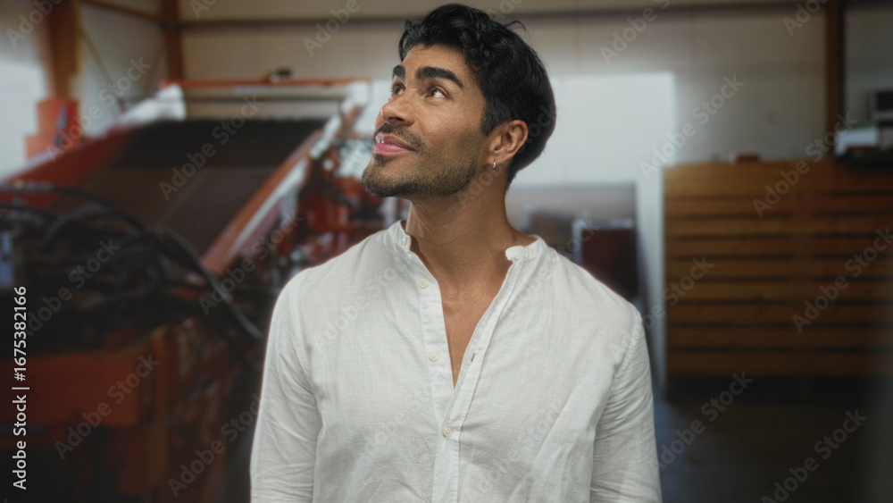 Obraz premium Man with dark hair smiles wearing white linen shirt in building; confidence motivation ambition growth.