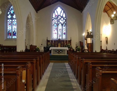 Church sanctuary interior with stained glass