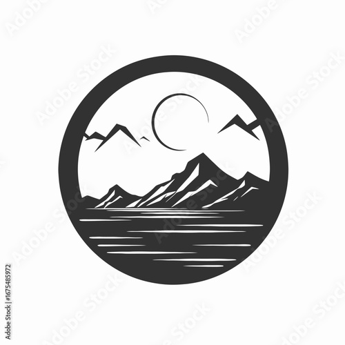 Dramatic mountain range and still water, captured in a dark silhouette.