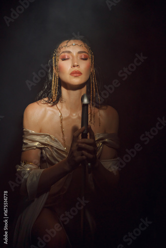 art photo real person fantasy woman queen eyes closed praying hands folded in prayer holding sword girl in dark room night moon light hope. white golden dress. Elf girl warrior on knees. sharp blade