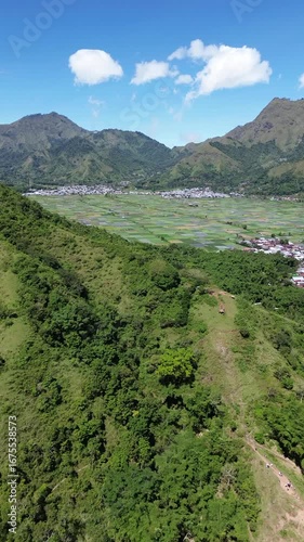 Aerial view of rice fields and mountainscape from Selong Hill, Sembalun Lawang, Lombok, West Nusa Tenggara, Indonesia.
