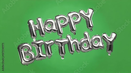 Celebrate joy with shimmering silver 'Happy Birthday' balloons floating against a vibrant green backdrop, perfect for festive events.