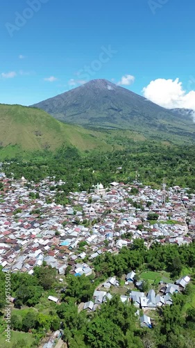 Aerial view of local residential house and mountainscape from Selong Hill, Sembalun Lawang, Lombok, West Nusa Tenggara, Indonesia.