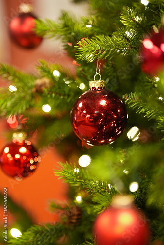 Christmas tree decorated with red shiny balls and LED garland