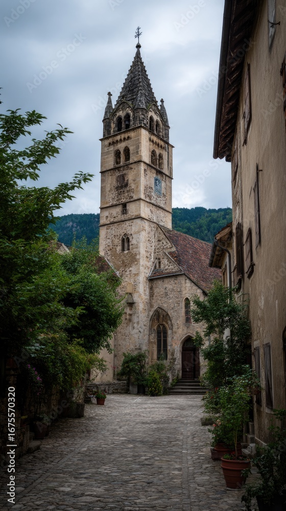 Fototapeta premium Historic church tower in a quaint village street