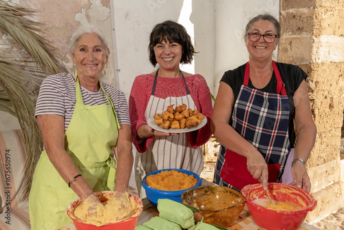 Obraz na plátně Mallorcan women smile while preparing buñuelos, Bunyols, typical food of Mallorc