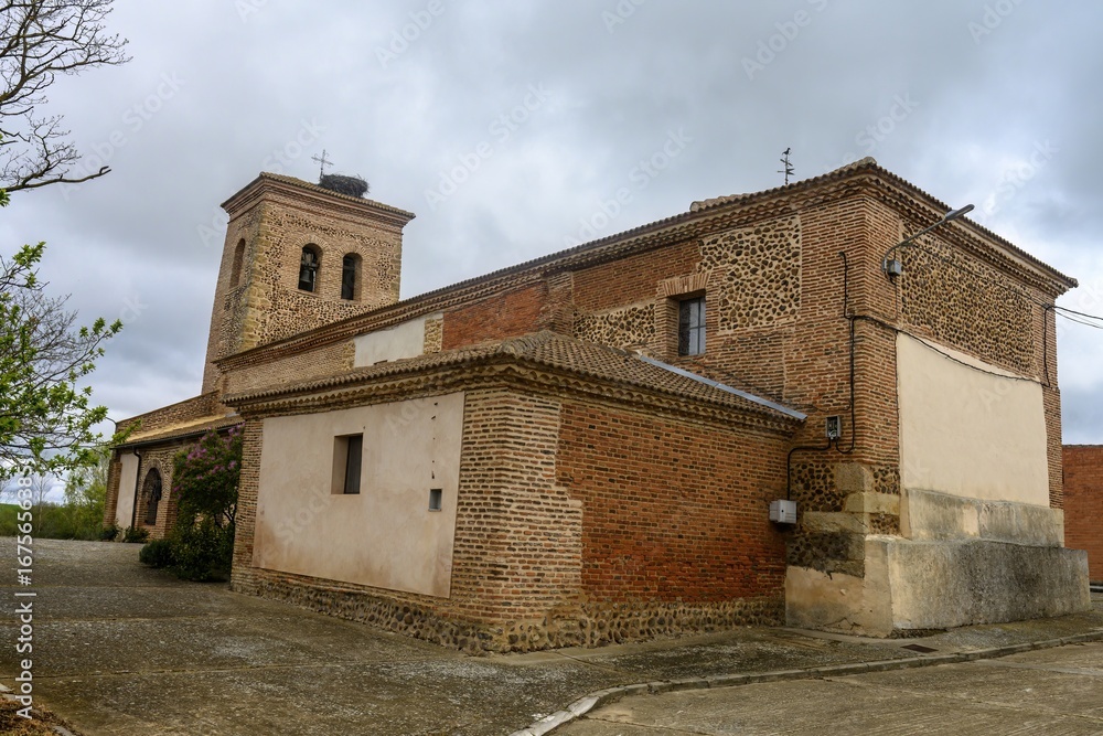 Obraz premium Church of Santa Ines in Villambroz, Palencia, with brick and stone bell tower