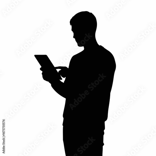 Silhouette of a man standing and using a digital tablet.
