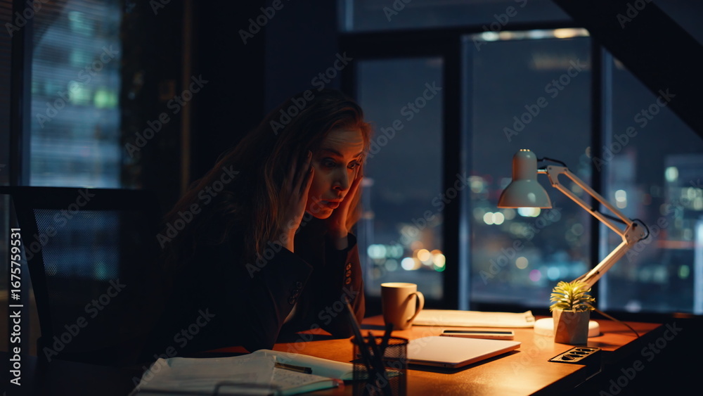 Fotografie Weary worker touching forehead remaining long hours inside workspace closeup