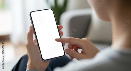 Close up of a person holding a smartphone with a blank white screen