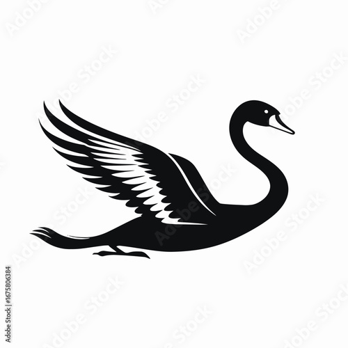 Majestic swan flying gracefully with outstretched wings in stark black silhouette