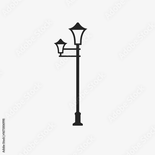Elegant black and white streetlight stands alone in stark contrast silhouette