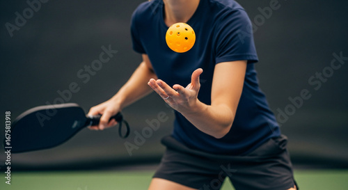 Three wooden pickleball paddles serving as trophies stand proudly behind a collection of various medals awarded at a sporting event.