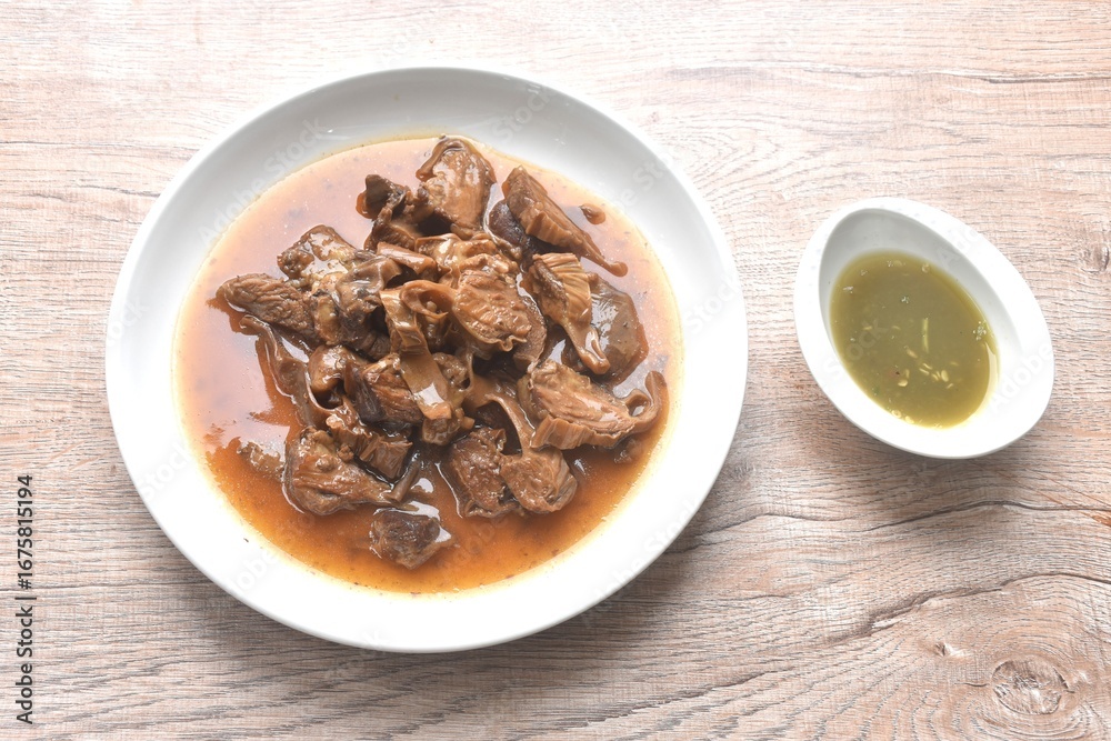 Fototapeta premium slice braised pork stew in herb brown soup dipping chili and sour sauce on plate