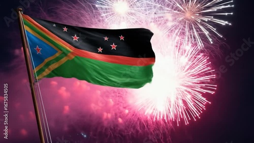 A national flag of a country billows proudly against a backdrop of spectacular fireworks.