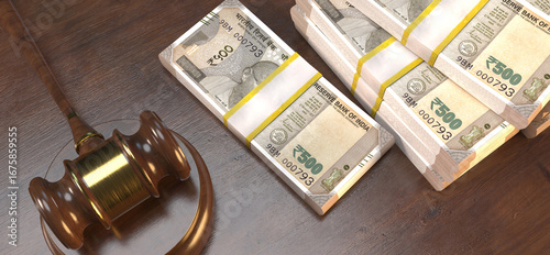 An image showing a judge's gavel next to stacks of Indian five hundred rupee notes on a wooden table.
