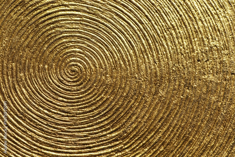 Fototapeta premium A radiant circular abstract pattern in gold shines with luxury, offering a detailed and decorative metallic finish.