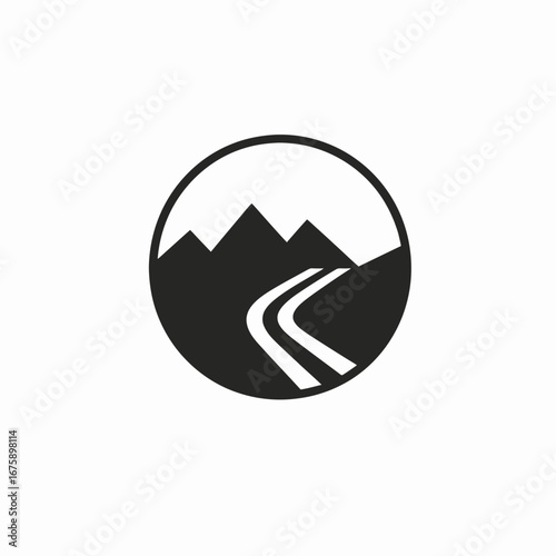 Dramatic mountainscape with winding road enclosed inside a circle silhouette