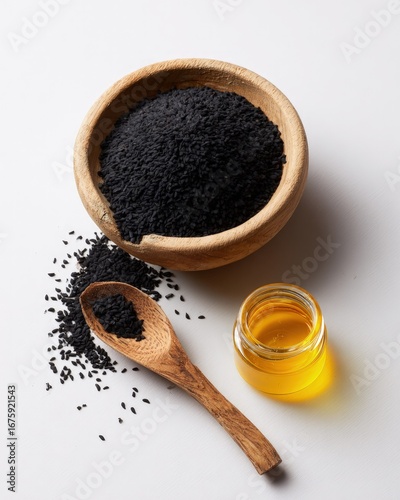 Black Sesame Seeds In Wooden Bowl With Sesame Oil