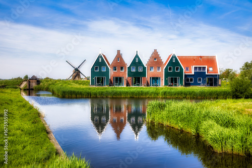 Typical Dutch Scene in Volendam, with a Canal and an Old Windmill