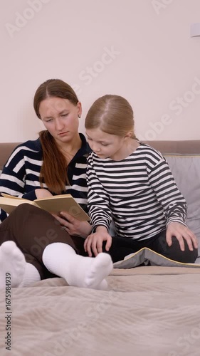 Mom is reading a book to her child, showing various expressions and emotions while sitting comfortably on a sofa, sharing a precious moment of bonding vertical video