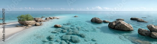 A serene beach with clear turquoise water, rocky outcrops, and a small patch of greenery under a blue sky.