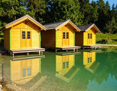 Wallpaper Mural Lakeside cabins reflect in tranquil water Torontodigital.ca