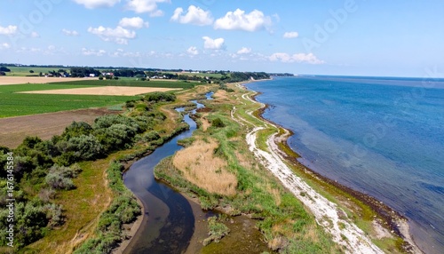 Wallpaper Mural Serene Coastal Landscape with River and Green Fields Under Blue Sky Torontodigital.ca