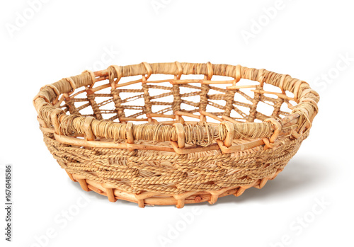 Isolated wicker basket or rattan basket. Weaved pattern. Used for storage, fruits or bread or organizing. Selective focus. White background.