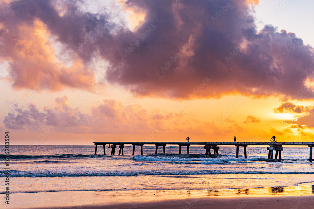 Fototapeta premium Butwani bridge and Malindi Pier area is a popular waterfront location known for stunning sunrises over the Indian Ocean. The pier is a concrete jetty that stretches about 400 meters into the ocean and