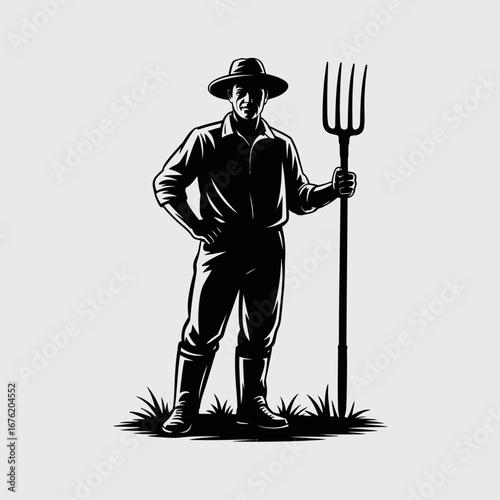 Silhouette of a farmer holding a pitchfork standing in a field