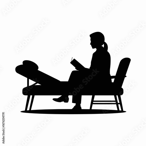 Silhouette of a person reading a book while sitting on a chaise lounge