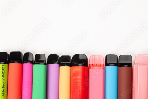 A set of colorful disposable electronic cigarettes of different shapes on a white background. modern smoking.