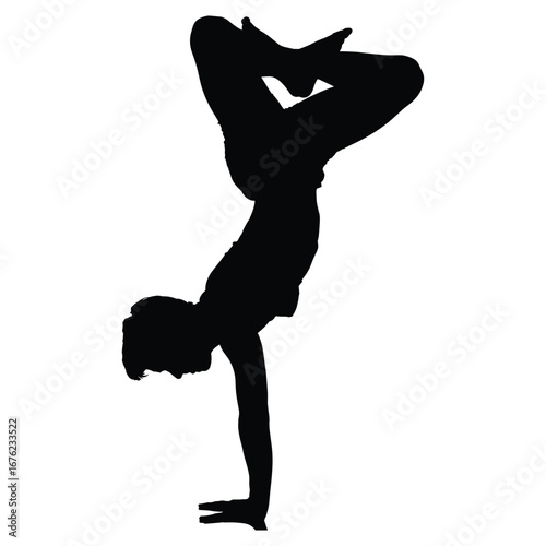 Agile dancer performing a challenging handstand pose silhouette