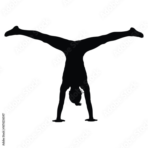 Woman performing a handstand with legs spread wide in silhouette