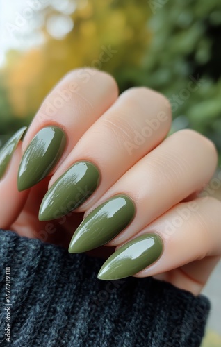 Elegant Green Nail Design With Pointed Tips Displayed Outdoors in Natural Light