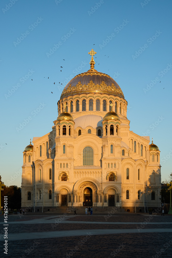 Fototapeta premium A stunning cathedral stands majestically at sunset, crowned with a beautiful golden dome