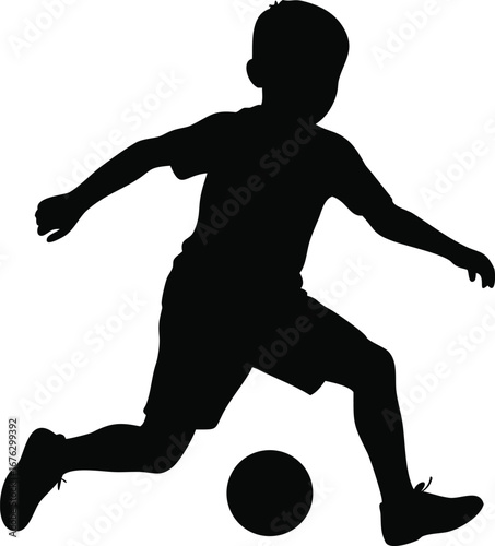 Silhouette of a young boy playing soccer kicking ball energetic childhood sports activity motion silhouette