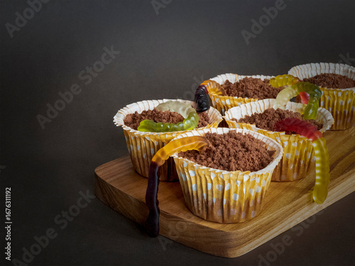 Creepy-cute Halloween cupcakes with gummy worms. Perfect spooky treats for Halloween parties and themed events