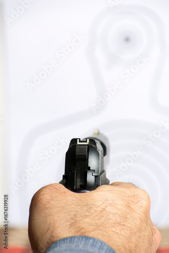 Close-Up of a Precision Semi-Automatic Pistol Rear holding by mature man