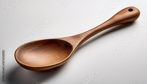 rustic wooden spoon lying on a white backdrop