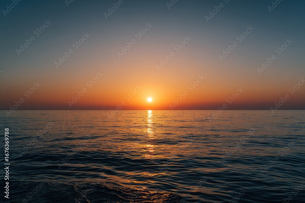 Naklejka premium Wide shot of a serene sunset over a calm sea