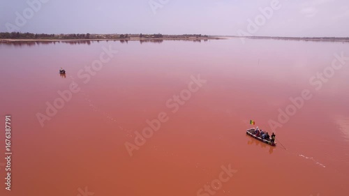 SENEGAL - 7.14.2025 - Gorgeous aerial footage of men rowing boats across Dakar, Senegal's Pink Lake.