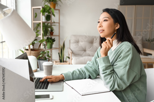 Young Asian woman working w...