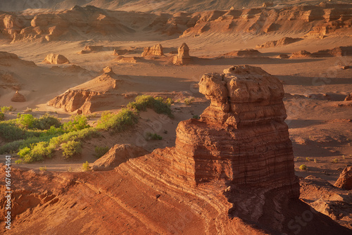 Stunning Desert Landscape with Rock Formations and Green Flora Oasis