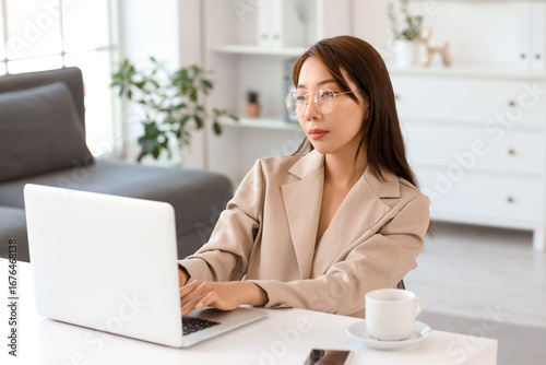 Asian businesswoman working...