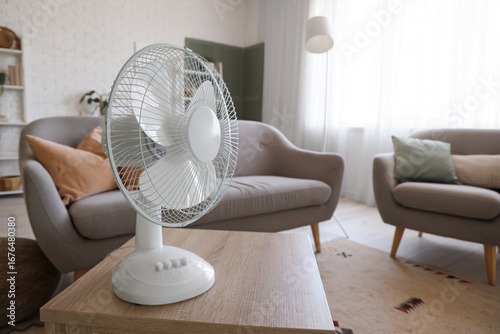 Electric fan on table in li...