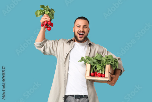 Young man with box of ripe ...