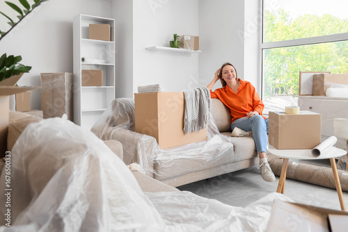 Young woman with moving box...