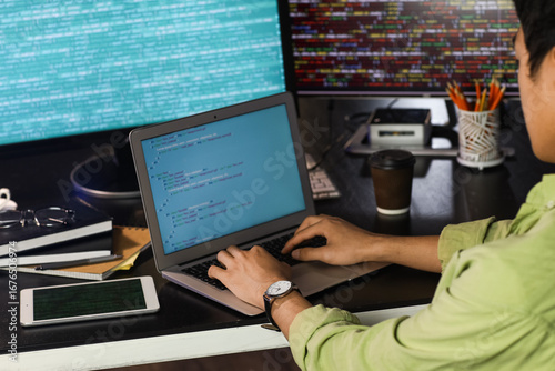 Male programmer working wit...